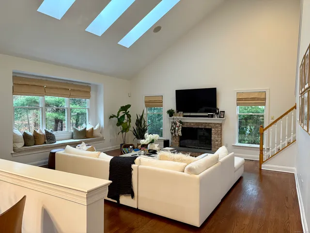 a living room with furniture a fireplace and a flat screen tv