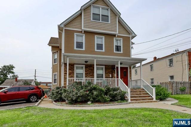 407 Hudson Street, Unit 1 Hackensack, NJ 07601 - Photo 1 of 8 a front view of a house with a garden