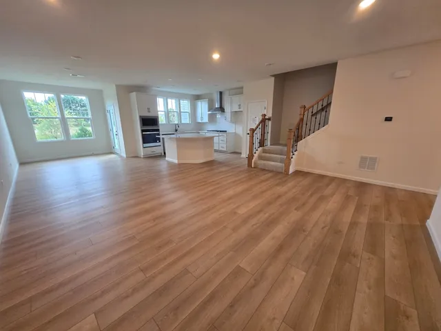 a living room with hardwood floor and a window
