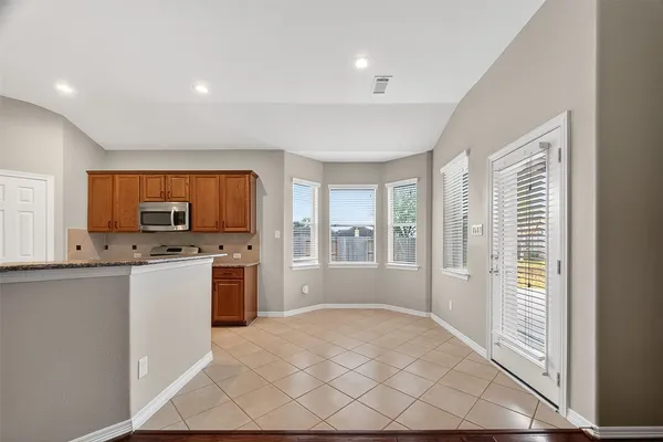 a view of a room with a ceiling fan and a chandelier fan