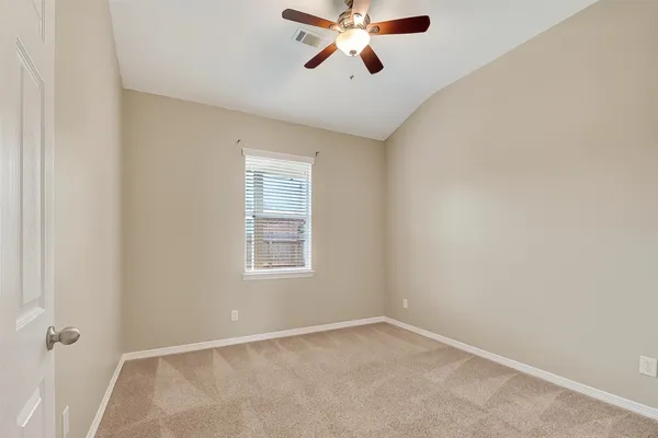 an empty room with a empty space and a ceiling fan