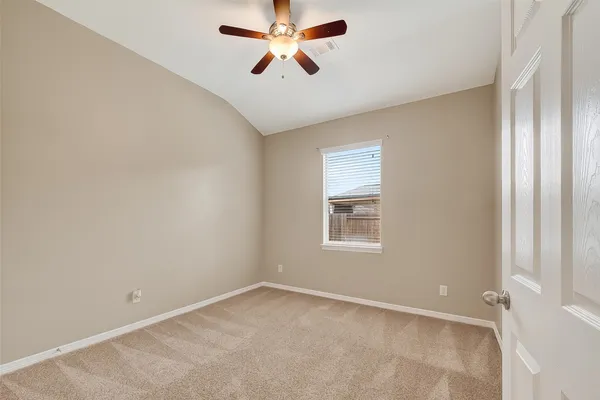 a view of an empty room with a ceiling fan