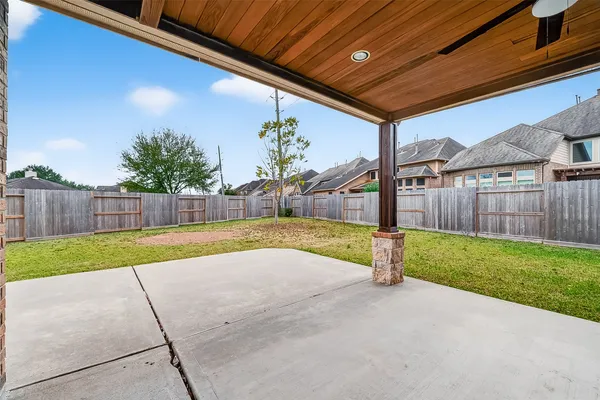 a view of a house with backyard and a tree