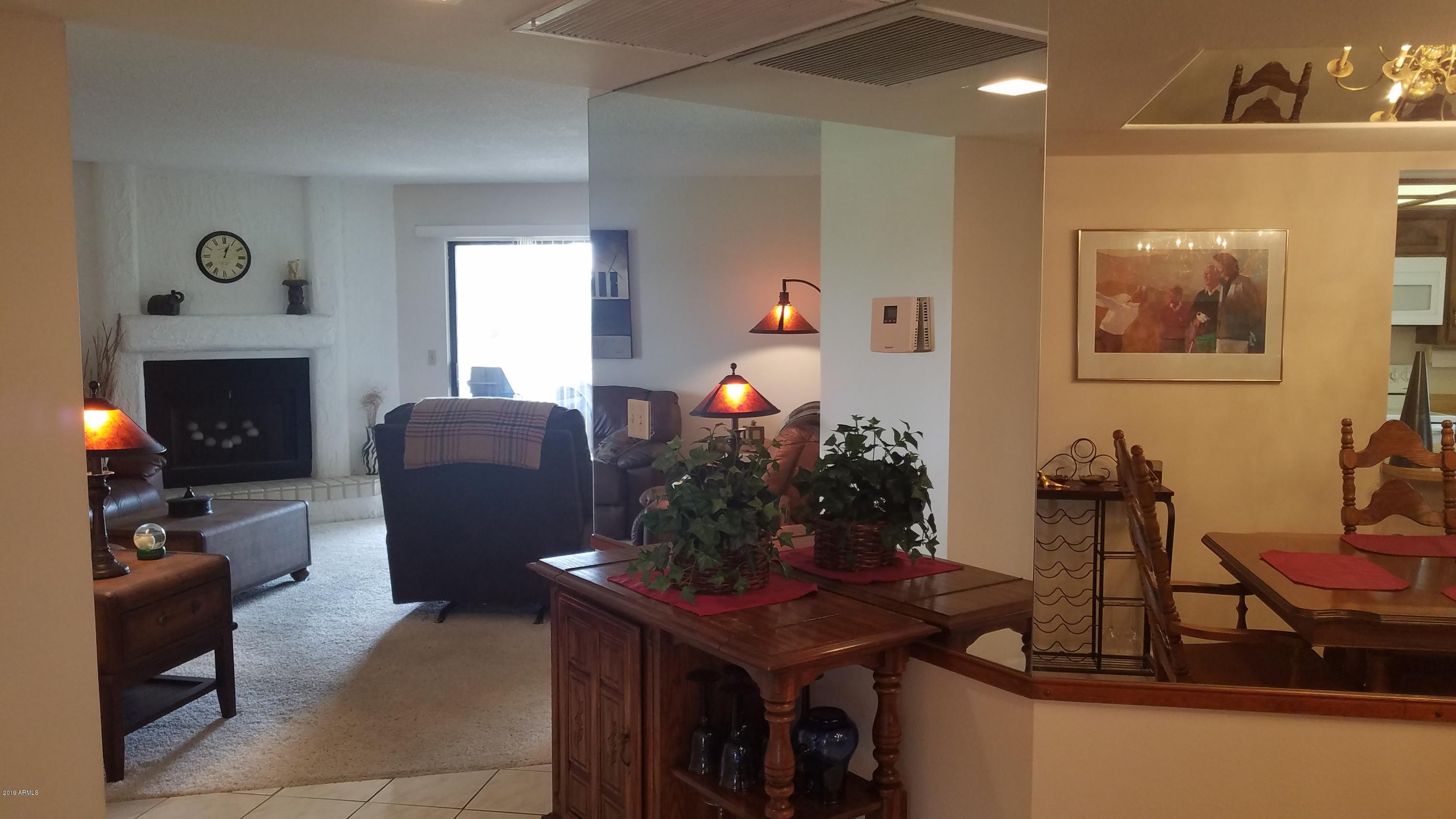 7061 East Broadway Road, Unit 48 Mesa, AZ 85208 - Photo 14 of 41 a living room with furniture and a fireplace