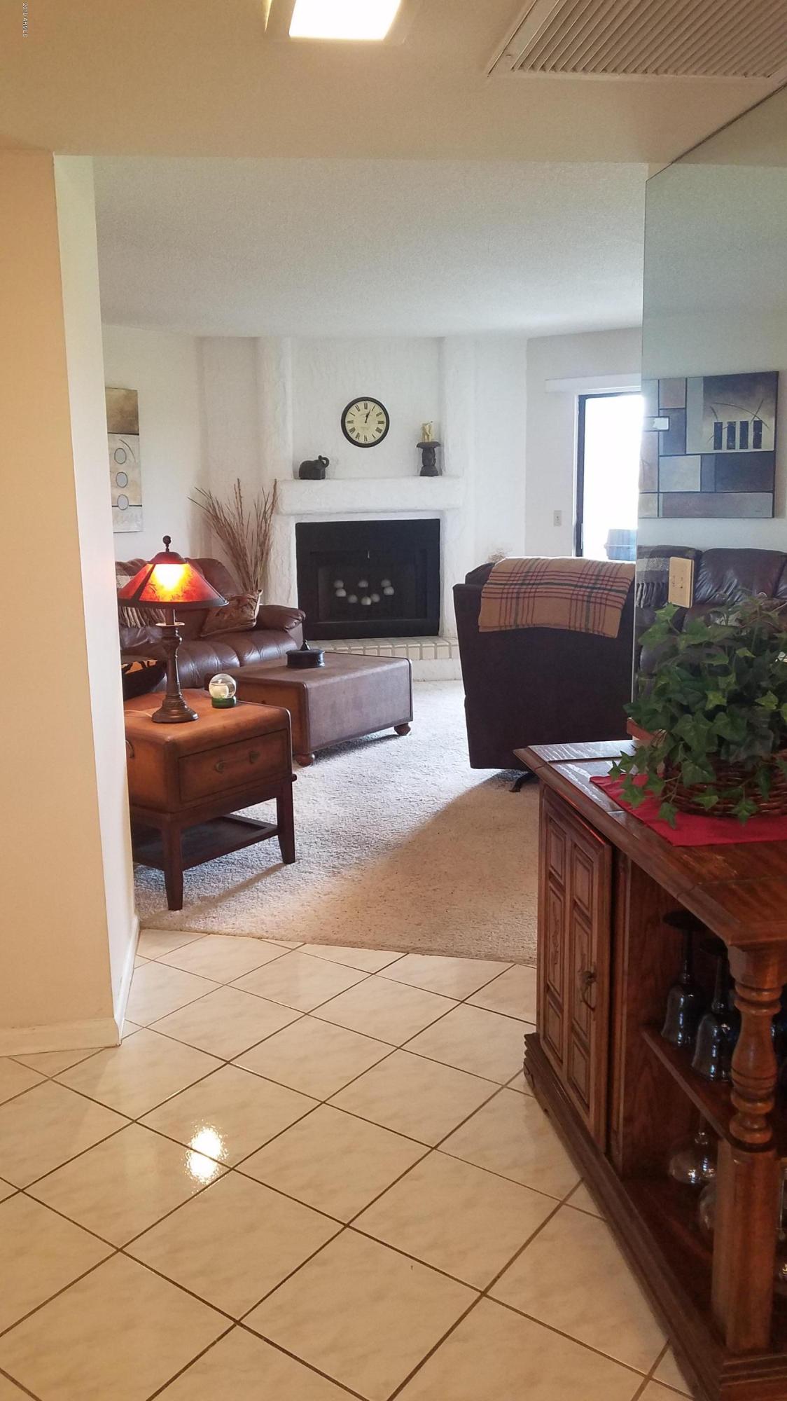 7061 East Broadway Road, Unit 48 Mesa, AZ 85208 - Photo 15 of 41 a living room with furniture and a fireplace