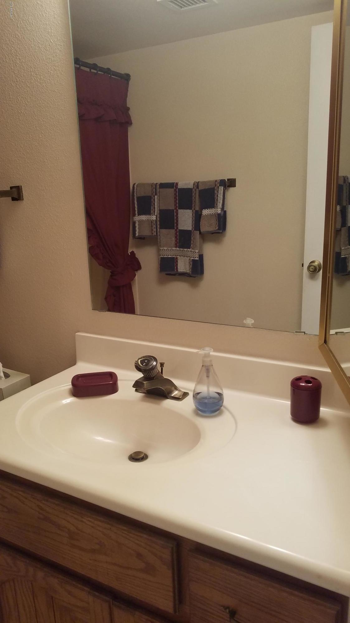7061 East Broadway Road, Unit 48 Mesa, AZ 85208 - Photo 22 of 41 a bathroom with a sink and a mirror