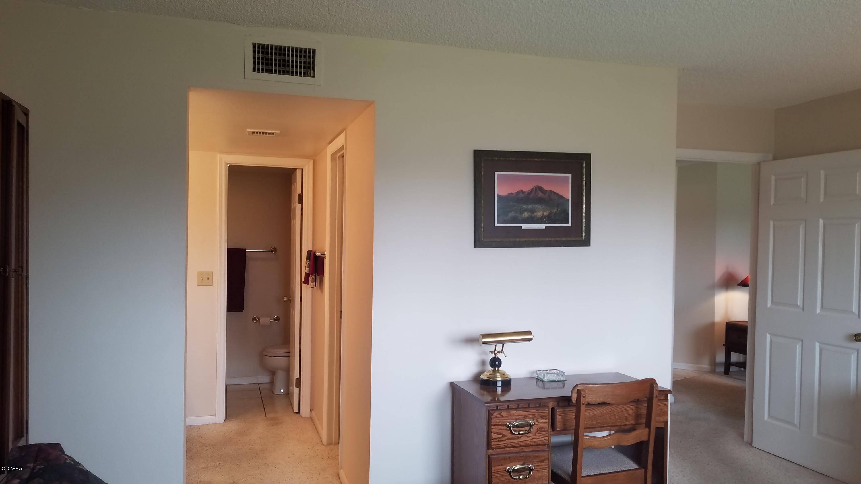 7061 East Broadway Road, Unit 48 Mesa, AZ 85208 - Photo 28 of 41 a view of a hallway with seating area