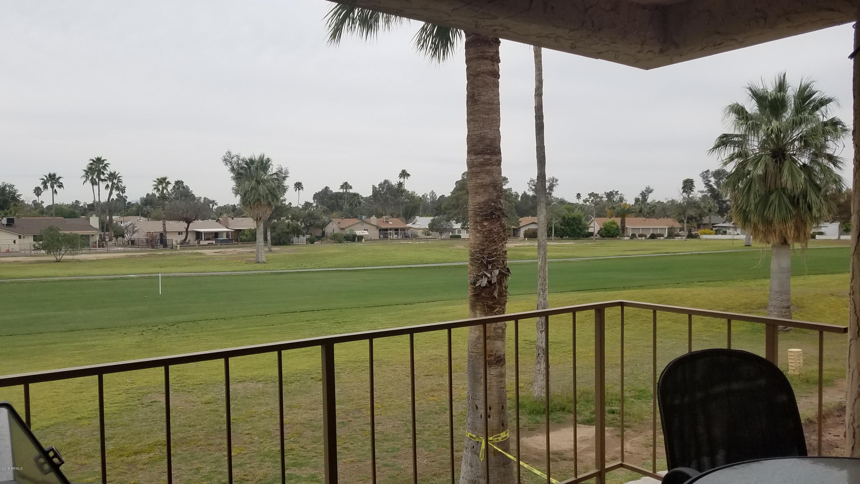 7061 East Broadway Road, Unit 48 Mesa, AZ 85208 - Photo 32 of 41 a view of a patio with a table chairs and a table