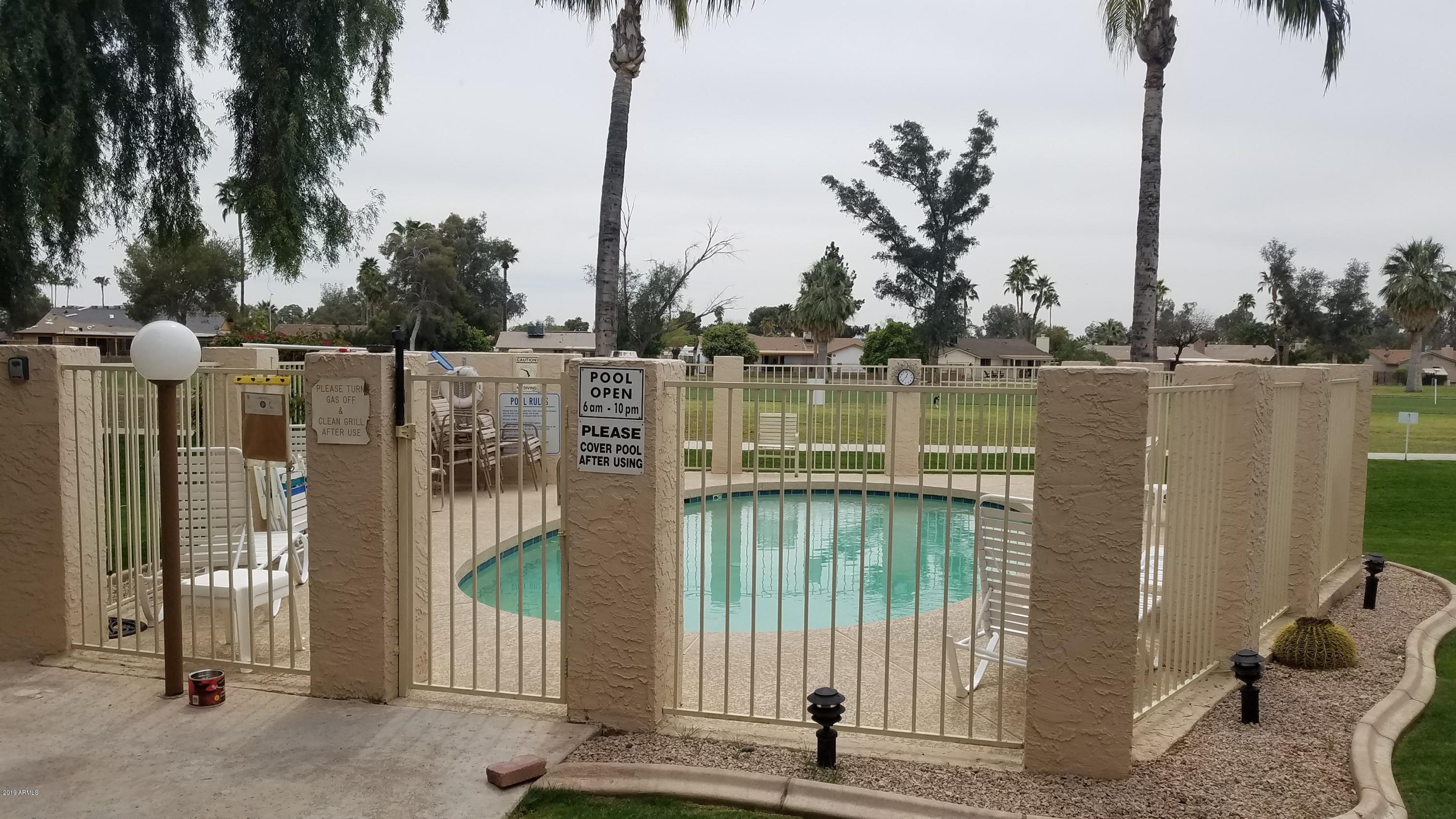 7061 East Broadway Road, Unit 48 Mesa, AZ 85208 - Photo 38 of 41 a view of a lake with boats and trees in the background