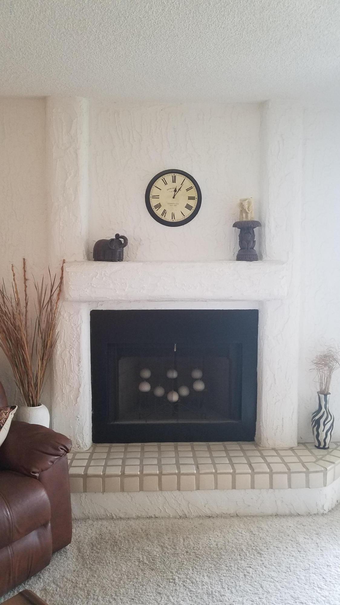 7061 East Broadway Road, Unit 48 Mesa, AZ 85208 - Photo 5 of 41 a living room with furniture and a fireplace