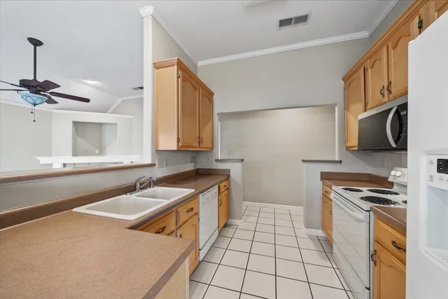 a kitchen with a sink a stove and cabinets