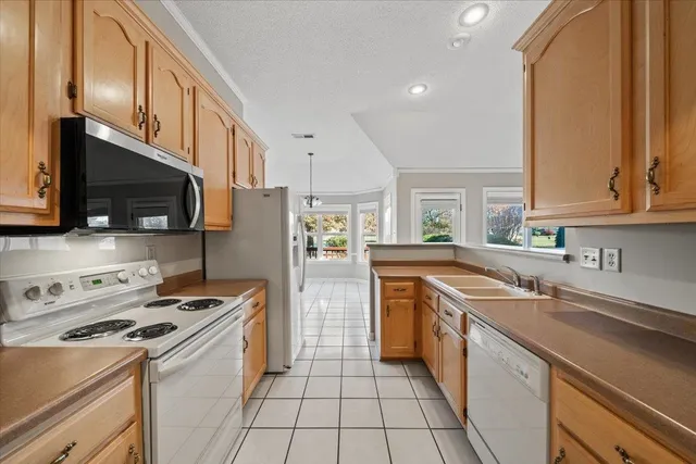 a kitchen with stainless steel appliances a stove sink microwave and cabinets