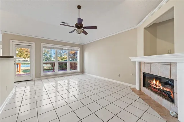 a view of an empty room with window and fire place