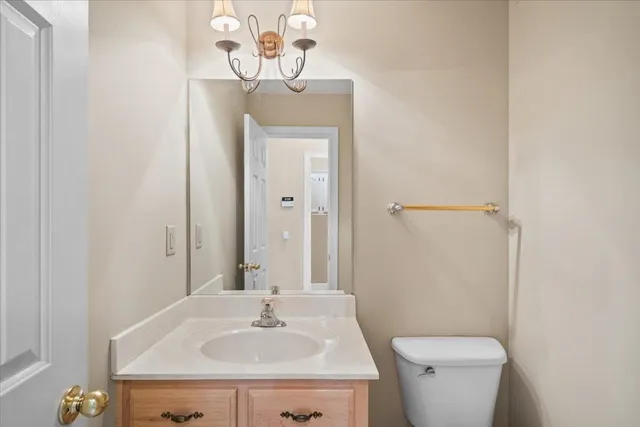a bathroom with a sink a toilet and mirror