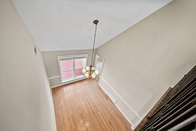 a view of a room with wooden floor