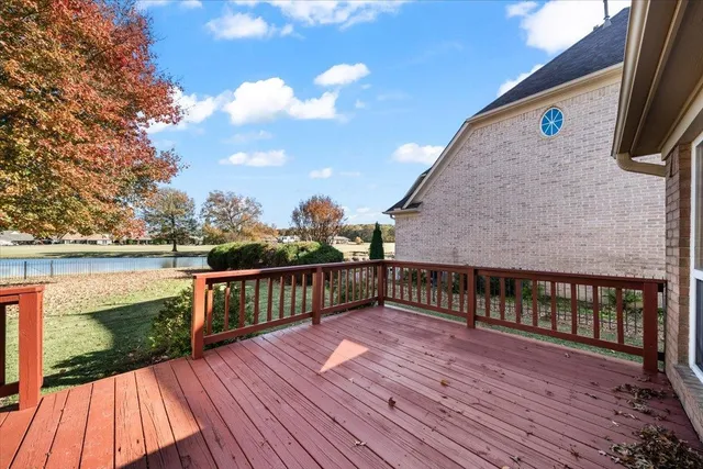 a view of a balcony with wooden floor and fence