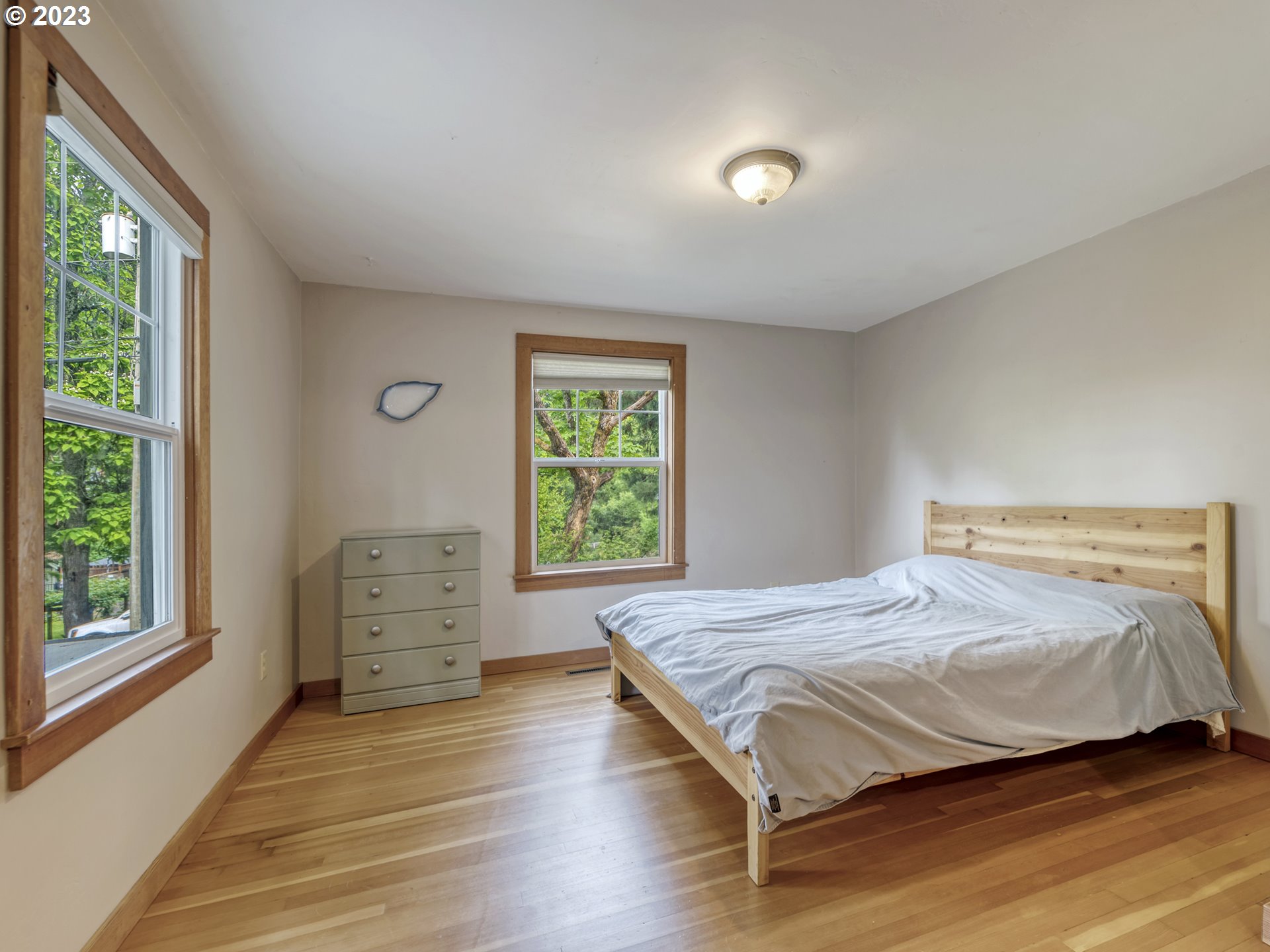 2660 Emerald Street Eugene, OR 97403 - Photo 13 of 36 a bedroom with a bed and wooden floor
