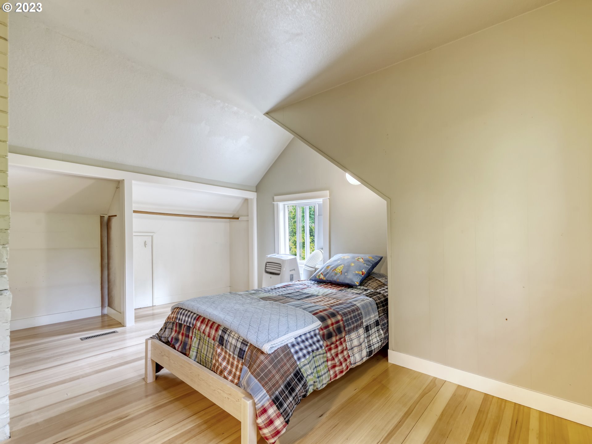 2660 Emerald Street Eugene, OR 97403 - Photo 18 of 36 a bedroom with a bed and wooden floor