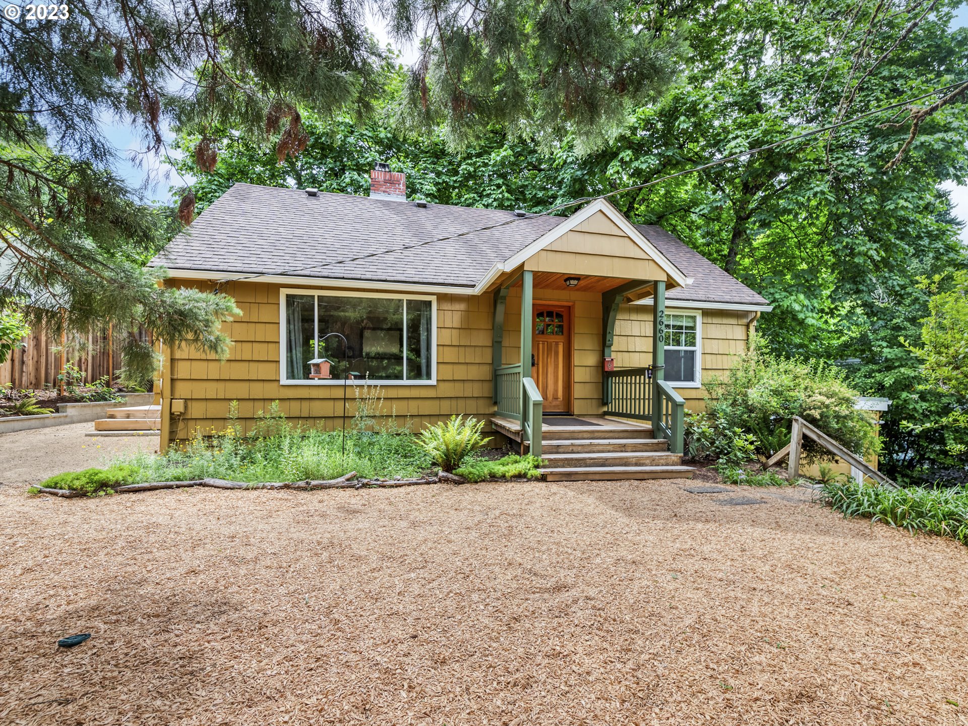 2660 Emerald Street Eugene, OR 97403 - Photo 2 of 36 a front view of a house with a garden