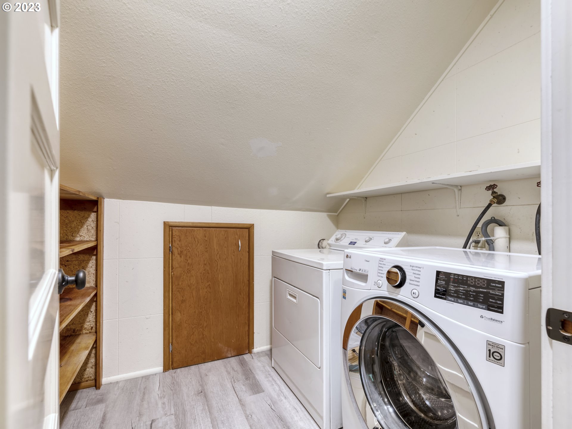 2660 Emerald Street Eugene, OR 97403 - Photo 21 of 36 a view of washer and dryer with kitchen in the background