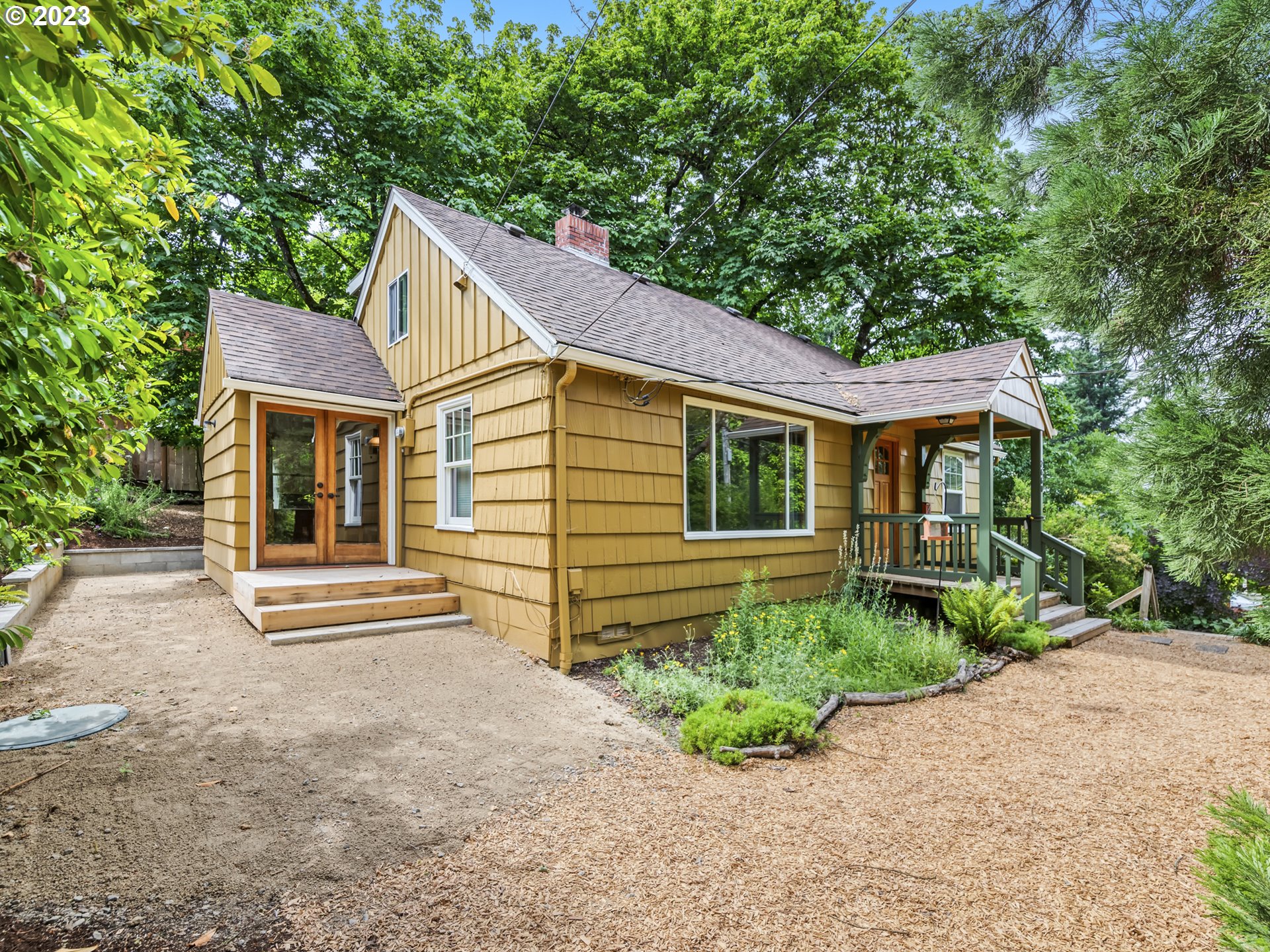 2660 Emerald Street Eugene, OR 97403 - Photo 29 of 36 a front view of a house with a yard and potted plants