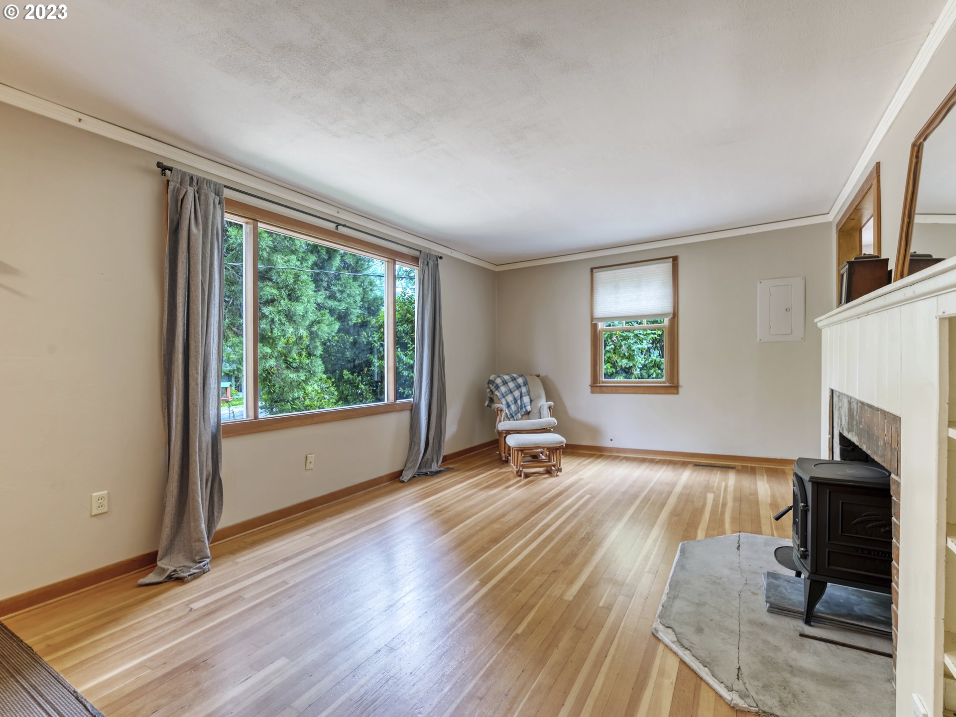 2660 Emerald Street Eugene, OR 97403 - Photo 4 of 36 a view of a livingroom with a fireplace and a window