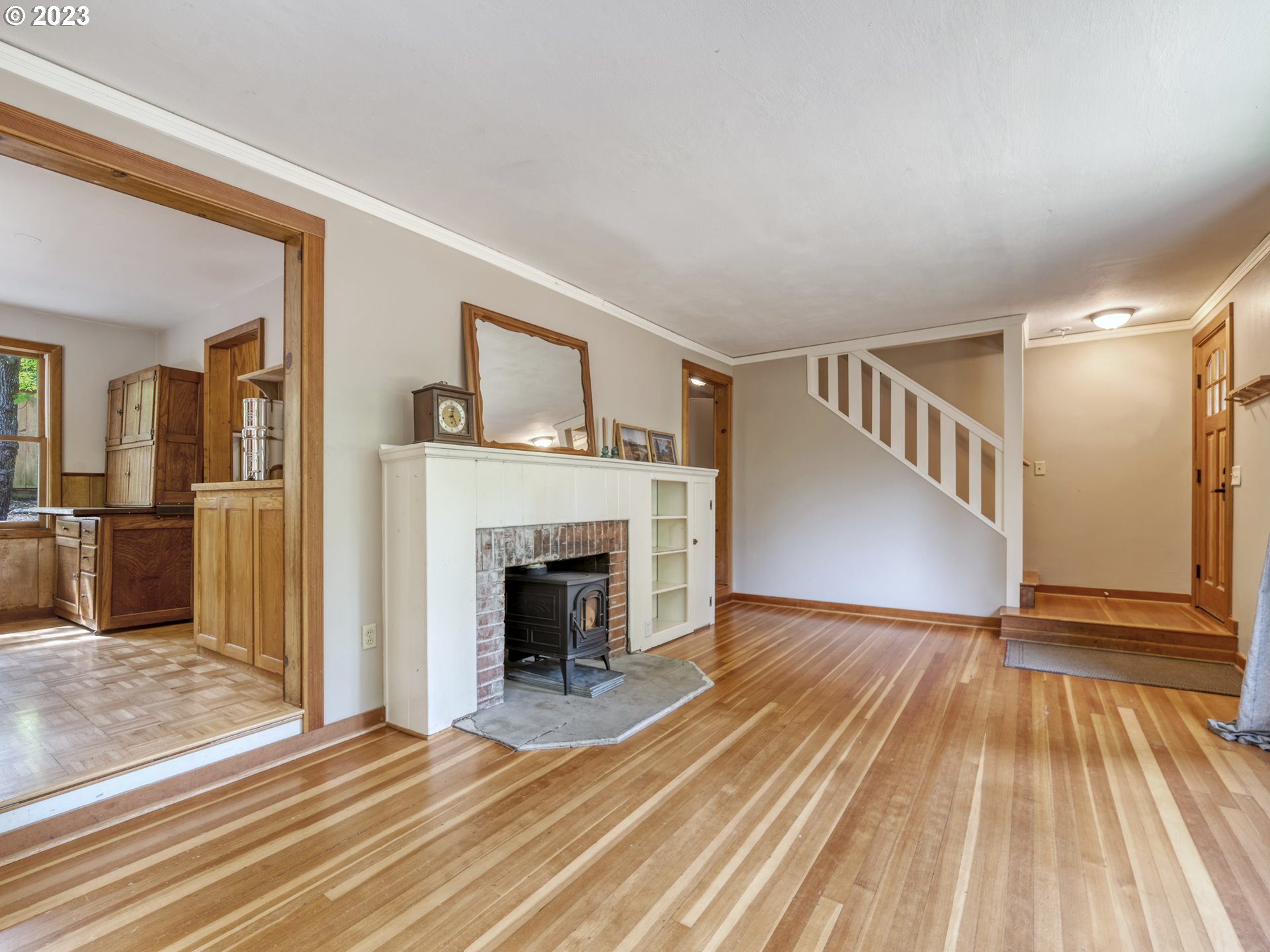 2660 Emerald Street Eugene, OR 97403 - Photo 5 of 36 a view of a livingroom with wooden floor and a kitchen