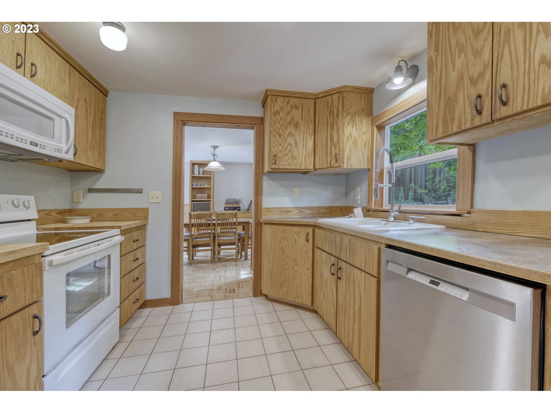 2660 Emerald Street Eugene, OR 97403 - Photo 10 of 36 a kitchen with a stove a sink and a refrigerator