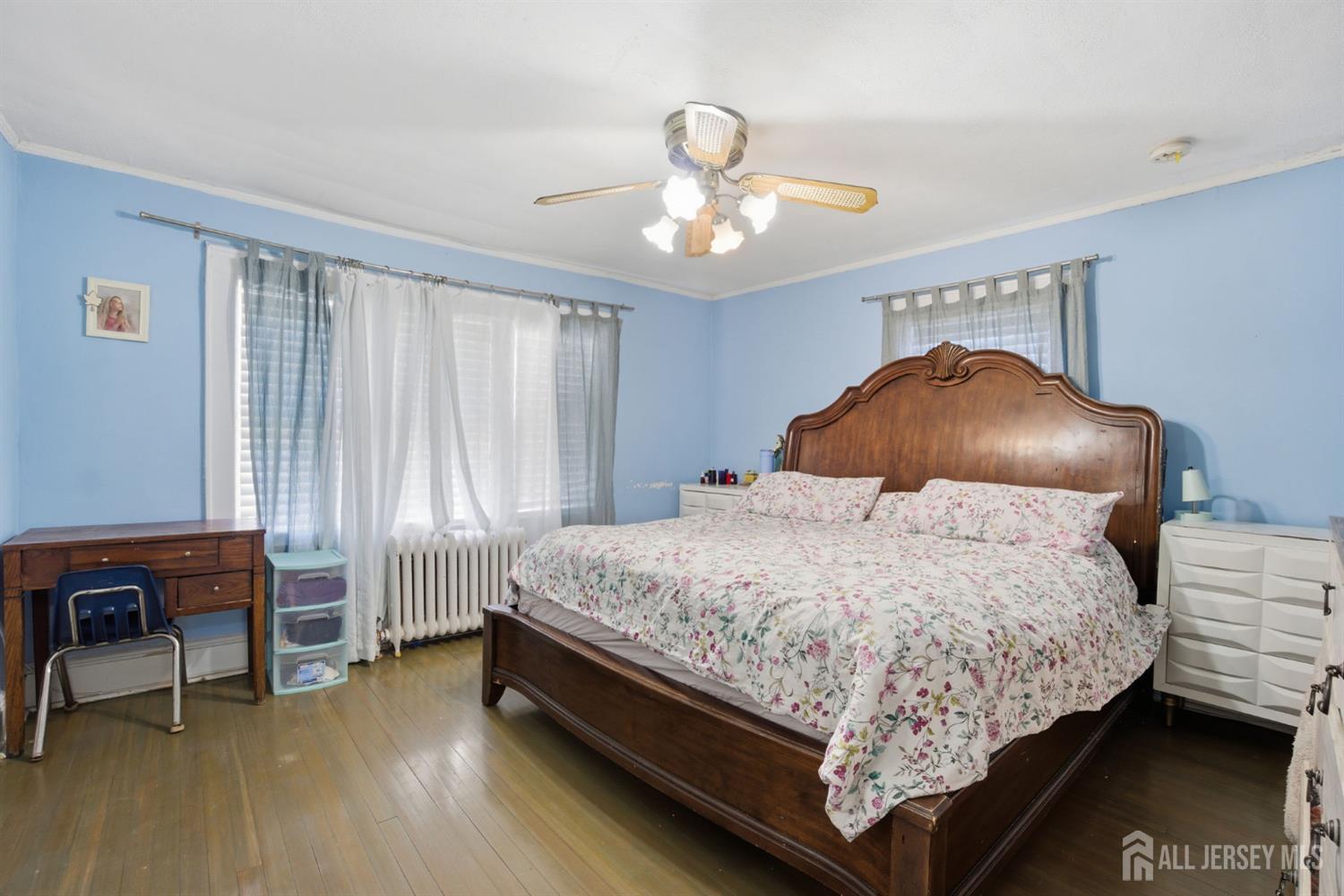 241 Hillside Road Elizabeth, NJ 07208 - Photo 13 of 33 a bedroom with a bed and a chandelier