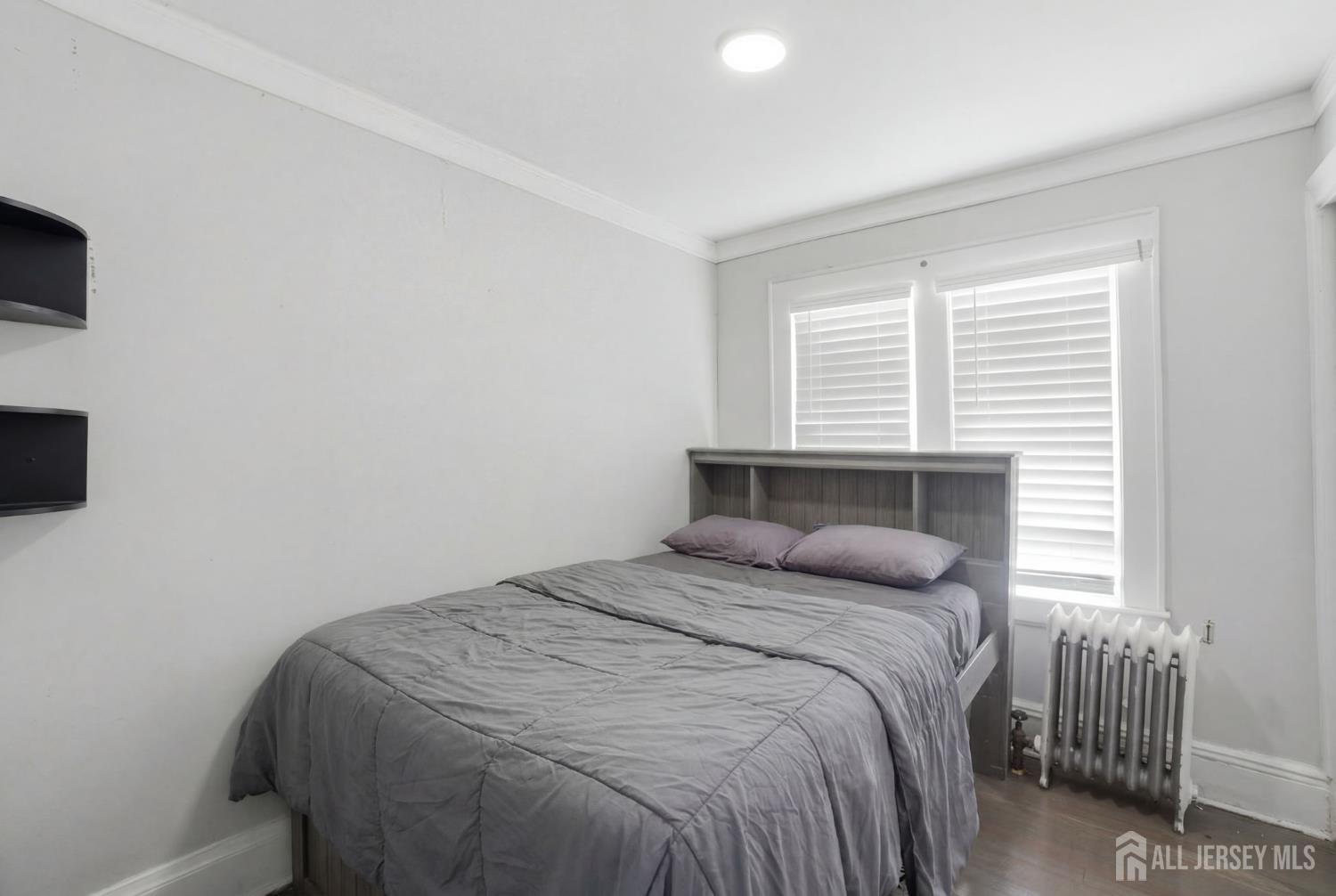 241 Hillside Road Elizabeth, NJ 07208 - Photo 15 of 33 a bedroom with a bed and a window