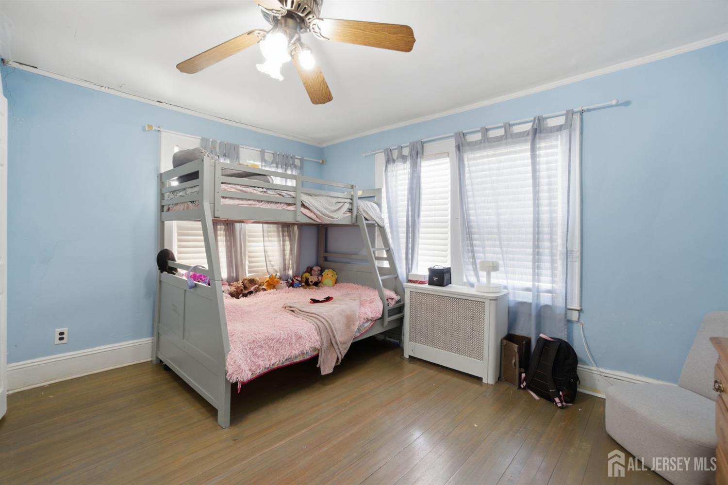 241 Hillside Road Elizabeth, NJ 07208 - Photo 16 of 33 a bedroom with a bed and a chandelier