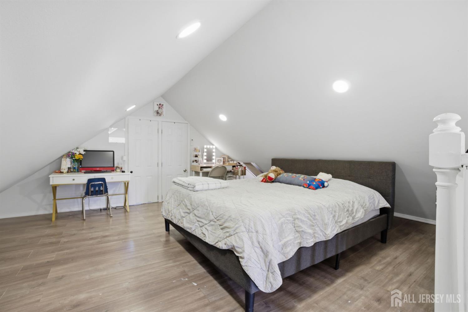 241 Hillside Road Elizabeth, NJ 07208 - Photo 18 of 33 a bed sitting in a bedroom next to a table and chair