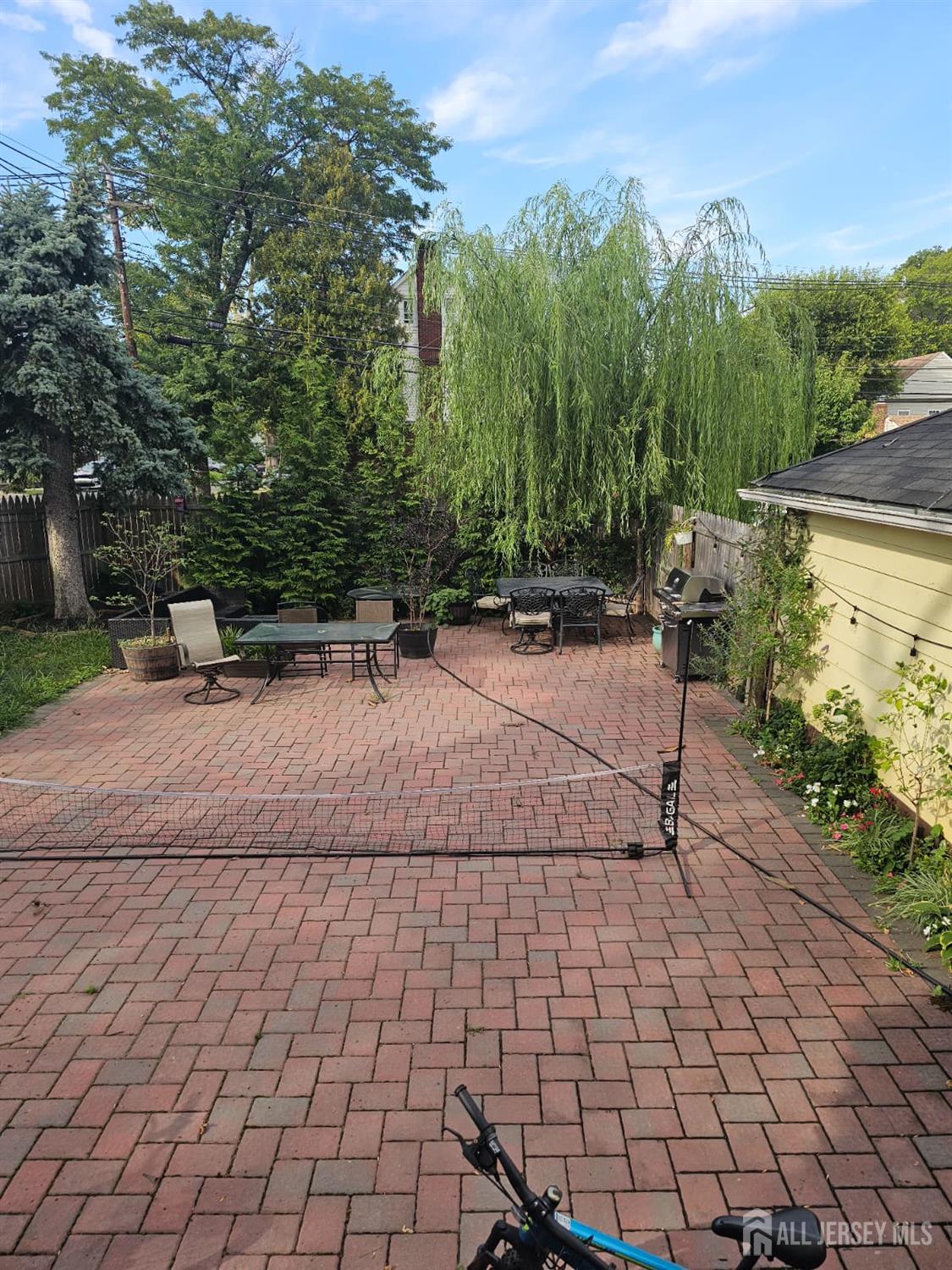 241 Hillside Road Elizabeth, NJ 07208 - Photo 30 of 33 a backyard of a house with lots of green space and trees