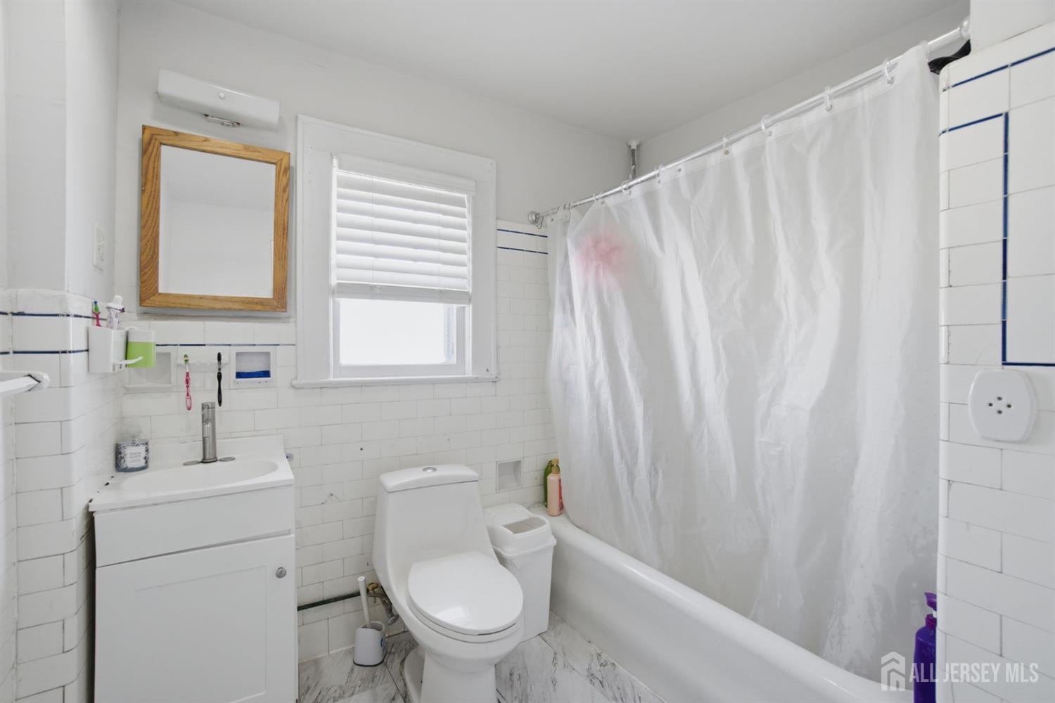 241 Hillside Road Elizabeth, NJ 07208 - Photo 10 of 33 a white toilet sitting next to a bathroom sink