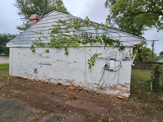 a view of a patio with table and chairs under an umbrella