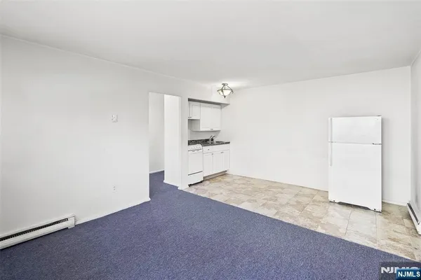 a view of a kitchen with a sink and a refrigerator