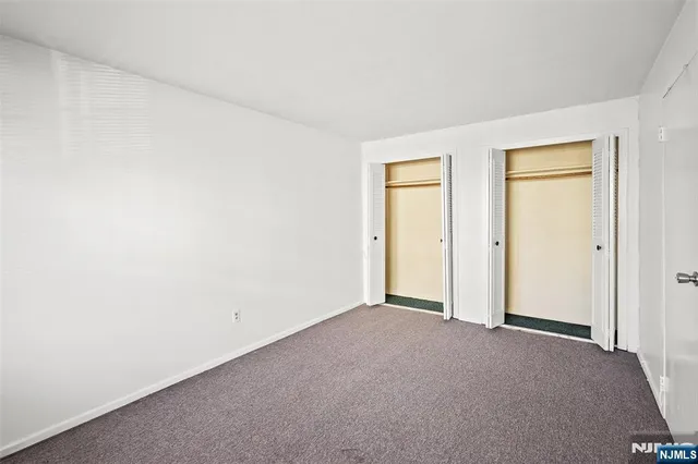 a view of an empty room and a window