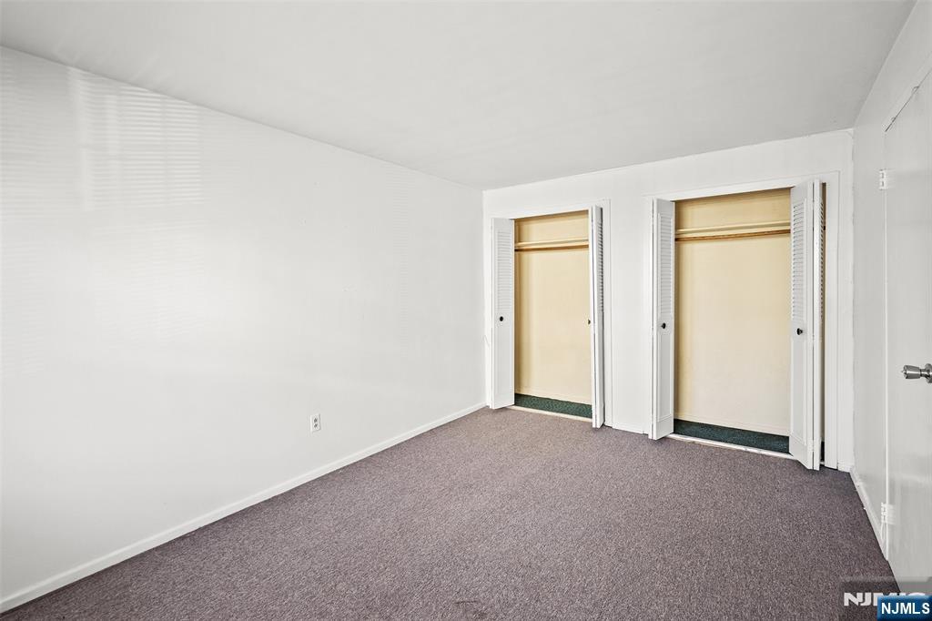 64 Poplar Avenue, Unit A7 Hackensack, NJ 07601 - Photo 8 of 10 a view of an empty room and a window