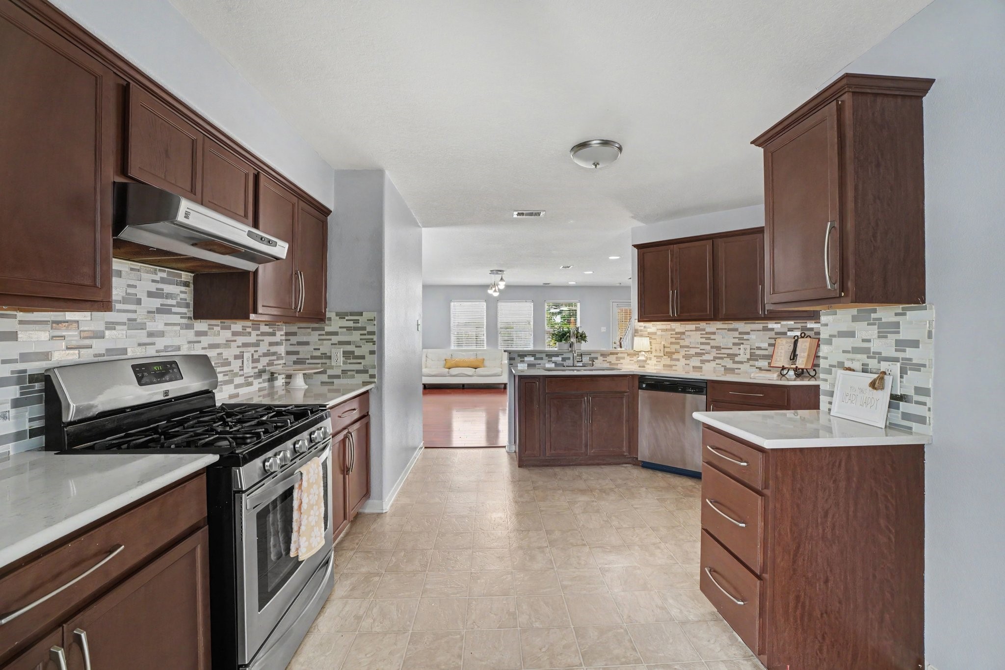 5622 Wasabi Lane Baytown, TX 77521 - Photo 7 of 29 a kitchen with stainless steel appliances granite countertop a stove sink microwave and cabinets