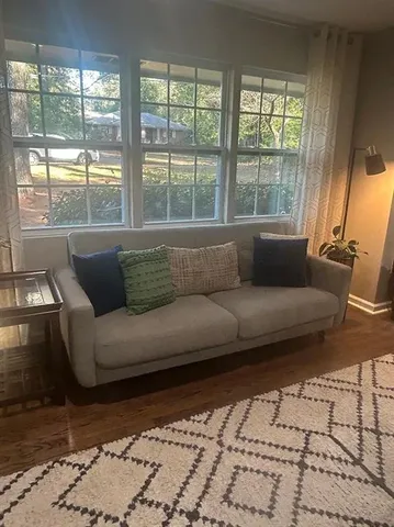 a living room with furniture and a large window