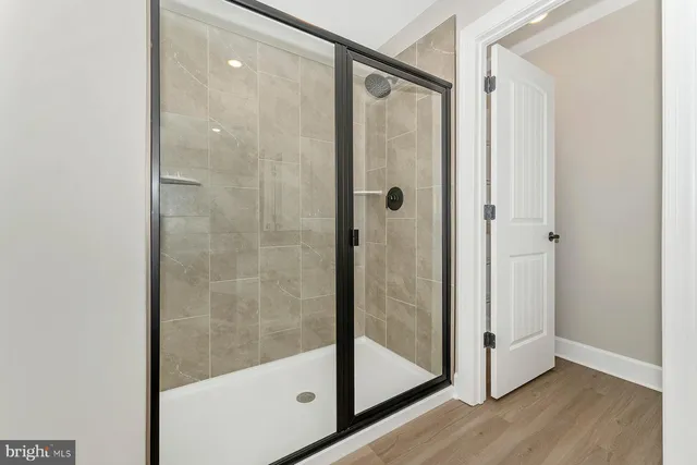 a bathroom with a glass shower door