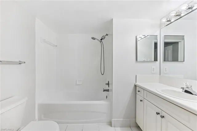 a bathroom with a tub sink toilet and mirror