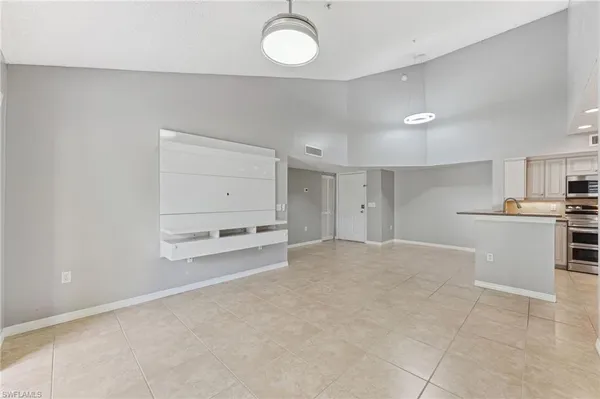a view of kitchen and empty room