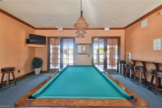 a room with lots of windows walls and wooden floor
