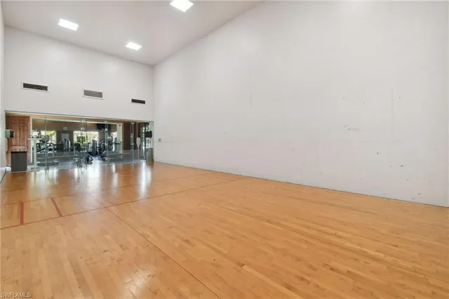 a view of empty room with wooden floor