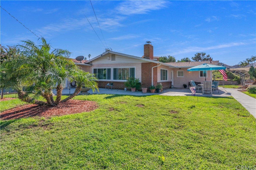a front view of a house with a big yard