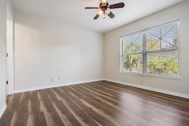 a view of room with window and ceiling fan