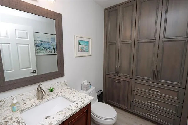 a bathroom with a granite countertop sink toilet and shower