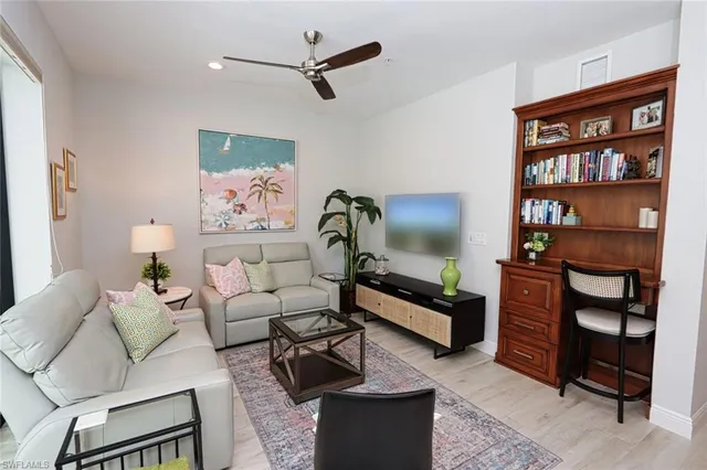 a living room with furniture a rug and a window