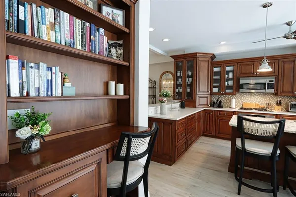 a kitchen with a table chairs refrigerator and cabinets